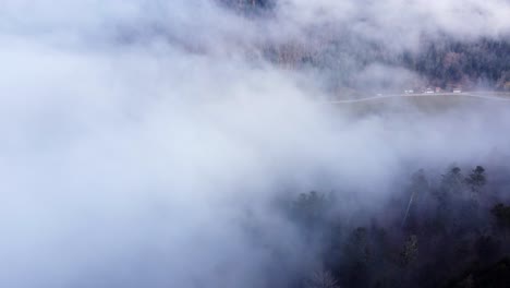 Moody-aerial-mountain-forest-in-clouds-and-fog-slow-relaxing-fly
