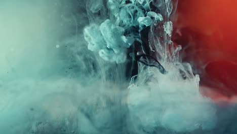Slow-motion-of-falling-blue-colored-nebula-and-red-lights-in-background---explode-magical-ink-effect
