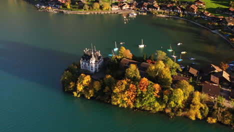 Cinematic-rotating-drone-shot-of-the-Iseltwald-Castle-on-Lake-Brienz-in-Switzerland