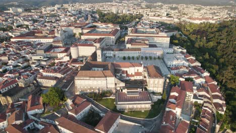 Aerial-pullback-universities-Square,-revealing-Riverside-Coimbra-Downtown,-Portugal