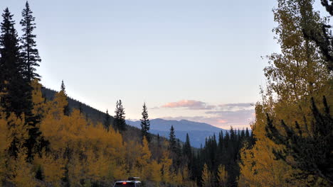 Autumn-Sunset-in-Mountains-with-Vehicle-Traveling