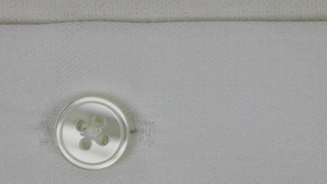 Four-Hole-Button-On-A-Plain-White-Cotton-Shirt