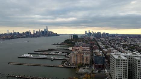 Aerial-view-of-Hoboken-and-the-Newport-of-Jersey-city,-sunset-in-New-York---tracking,-drone-shot