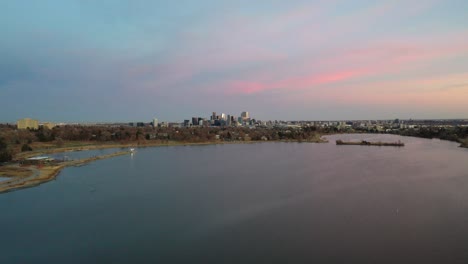 A-drone-flight-at-sunset-next-to-Sloan's-Lake,-Denver-Colorado