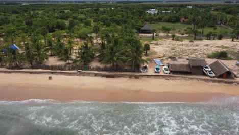 Drone-flying-from-jungle-over-beach-to-ocean-in-Arugam-Bay,-Sri-Lanka