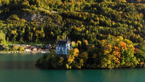 Cinematic-revealing-drone-shot-of-the-Iseltwald-Castle-on-Lake-Brienz-in-Switzerland