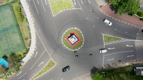 Aerial-top-down-view-spinning-over-busy-roundabout-with-tuk-tuks,-rickshaws-and-cars-driving-through-in-Galle,-Sri-Lanka