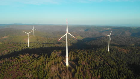 Four-Black-Forest-wind-mills-on-top-of-the-mountain-spinning-in-the-evening-sun-30fps-4k