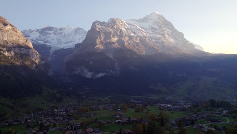 aerial-drone-footage-pushing-in-over-Grindelwald-village-and-Eiger-North-Face-at-sunset-in-autumn