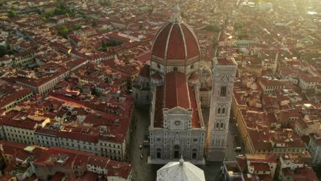 Church-in-city-center-of-Florence-during-sunrise,-Cathedral-Saint-Mary-of-the-Flower,-aerial