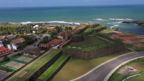 Aerial-rising-over-historic-Galle-Fort-with-ocean-and-landscape-in-the-background-in-Galle-in-the-south-coast-of-Sri-Lanka