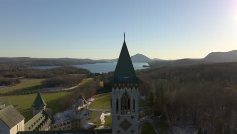 Saint-Benedict-Abbey-Overlooking-Lake-Memphremagog-In-Quebec,-Canada---aerial-ascending