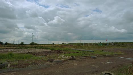 Wind-turbines-on-grey-cloudscape-in-UK-in-wasteland-setting