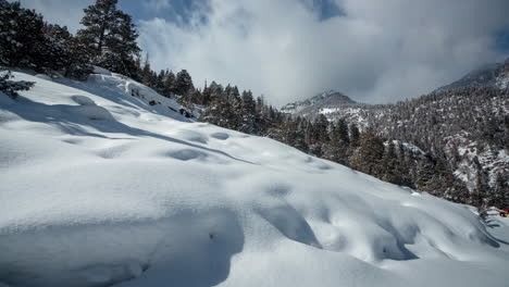 Time-Lapse-of-Serene-White-Winter-Landscape,-Snow-Capped-Mountain-Hills-on-Sunny-Day