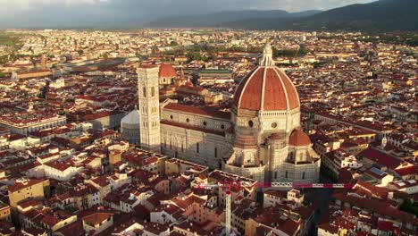 Morning-sunlight-shining-on-famous-Cathedral-Saint-Mary-of-the-Flower-in-Florence,-aerial