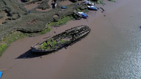 Aerial-Bird's-Eye-Above-Shipwreck-Remains-Stuck-on-Shore,-Essex,-UK