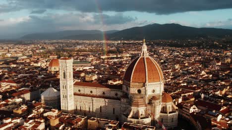 Florence-Cathedral-with-rainbow-illuminating-by-morning-bright-sunlight,-aerial