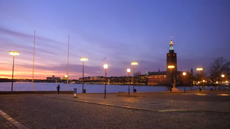 Panning-across-colorful-sunset-during-dawn-shot-from-Gamla-Stan-old-town-Evert-Taubes-Terrass-in-Stockholm,-Sweden