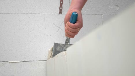 Worker's-Hand-Applying-Waterproofing-Coat-On-Concrete-Wall