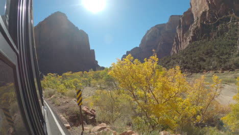 Shot-of-the-size-of-a-bus-driving-through-Zion-National-Park