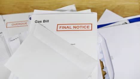 A-stack-of-bills-and-debts-with-a-gas-bill-final-notice-letter