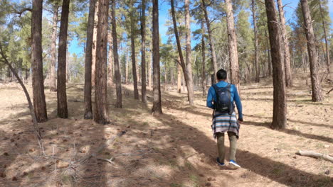 A-shot-of-a-young-Hispanic-man-hiking-around-the-woods