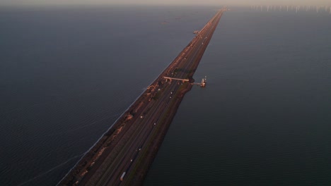 Aerial-view-of-Vlietermonument-on-large-Afsluitdijk-during-sunset,-Netherlands