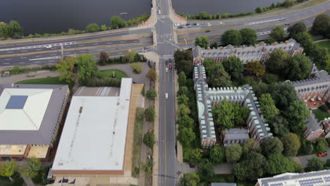 Flying-down-North-Harvard-Street-across-the-Anderson-Memorial-Bridge-toward-the-Harvard-University-campus-to-view-the-Elliot-House,-Weld-Boat-House-and-other-iconic-buildings