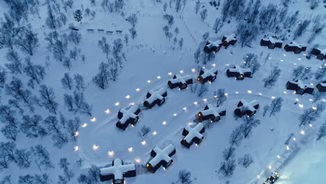 Aerial-top-down-shot-of-snowy-Snowhotel-Kirkenes-and-Gamme-Northern-Lights-Cabins-in-Norway