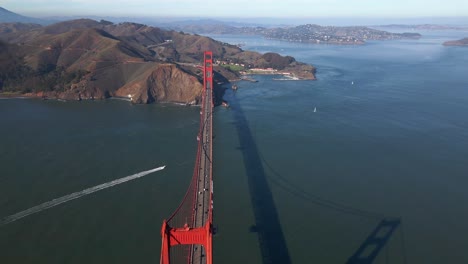 Aerial-view-over-the-historic,-Golden-gate-bridge---high-angle,-reverse,-drone-shot