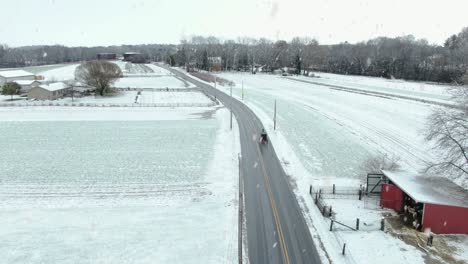 Aerial-of-Amish-horse-and-buggy-in-snowstorm-in-USA