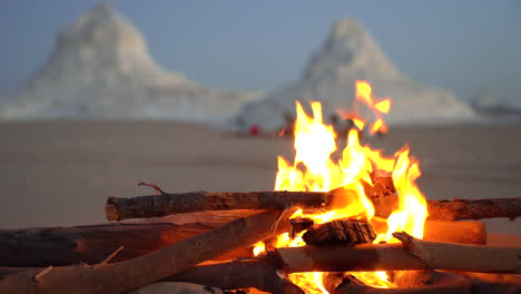 warm-bonfire-burning-fresh-wood-in-the-desert-during-the-sunset-waiting-for-night-camp-during-adventour-travel-tour