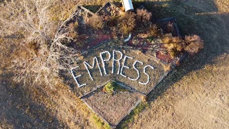 Drone-over-head-shot-of-a-garden-with-the-word-Empress-printed-with-white-rocks-in-Empress-Alberta-Canada