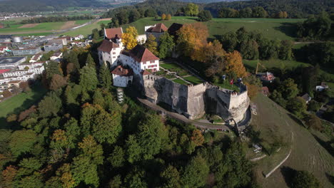 Fantastische-Luftaufnahme-Im-Orbit-An-Einem-Sonnigen-Tag-Von-Schloss-Lenzburg-Und-Wo-Die-Schweizer-Flagge-Zu-Sehen-Ist