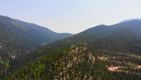 Lonely-Isolated-House-Cabin-On-Alpine-Woodlands-Mountain-Hill-Peak