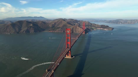 Aerial-view-of-traffic-on-the-famous,-red-Golden-gate-suspension-bridge---circling,-drone-shot