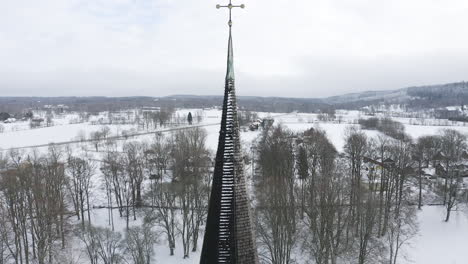 Drone-close-up-shot-of-a-church-bell-and-tower-in-the-middle-of-the-woods-of-Sweden