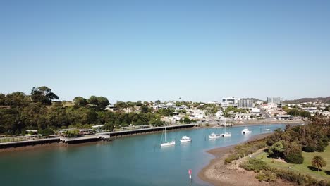 Drone-aerial-parallax-over-blue-harbour-on-seaside-town-on-summer-day