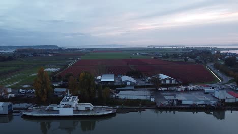 Aerial-Panning-Shoreline,-Fishing-Village-with-Boat-at-Sunset-Ladner-BC