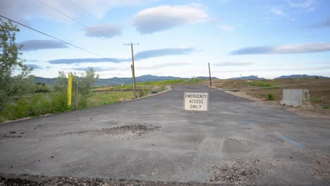 Road-closed-leading-to-new-housing-construction-in-the-mountains,-pan