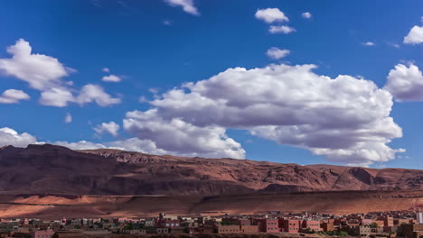 Cinematic-timelapse-of-moving-clouds-and-shadows-falling-on-the-high-atlas-mountain-of-Tinghir-town,-the-Moroccan-crown-jewel