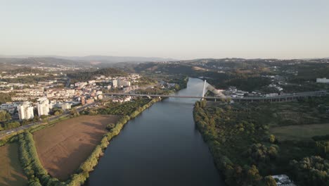 Cable-stayed-superstructure-over-Mondego-River-Rainha-Santa-Isabel-bridge-in-the-Coimbra-city-of-Portugal,-aerial-view