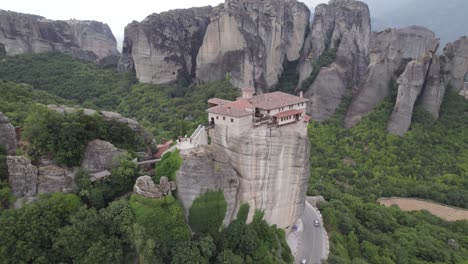 Aerial-arc-of-impressive-cliff-top-monastery-perched-on-massive-rock-column