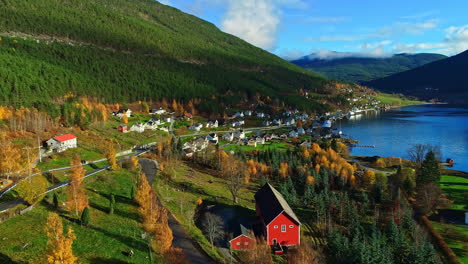 A-hillside-village-on-the-edge-of-a-fjord-in-Norway-during-autumn---aerial-flyover