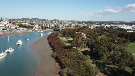 Drone-aerial-slow-pan-over-blue-harbour-with-ships-on-a-sunny-day