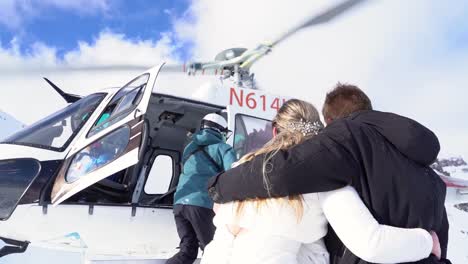 Bride-And-Groom-Boarding-Helicopter-In-Snowy-Rocky-Mountains