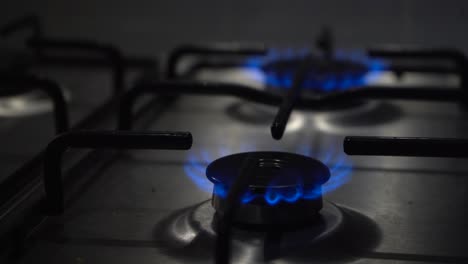 Narrow-focus:-Two-burners-on-gas-stove-are-lit-with-hot-blue-flames