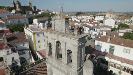 Aerial-orbiting-around-Our-Lady-of-Grace-or-Igreja-da-Graca-church-bell-tower-of-Evora-in-Portugal