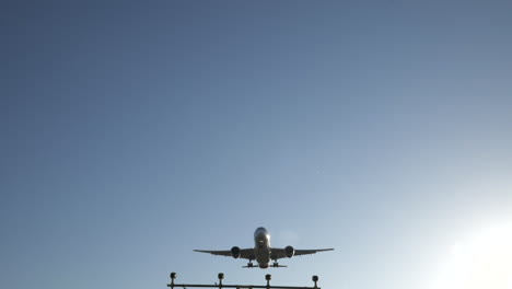 Slow-motion-commercial-passenger-jet-flies-overhead-on-final-approach