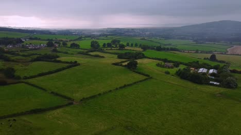Aerial-shot-of-British-countryside-green-fields-in-early-morning